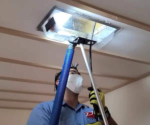 Technician using equipment to clean commercial air ducts in Wentzville MO