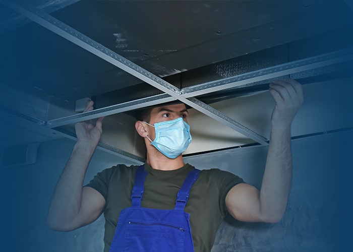 Technician performing commercial air duct cleaning in Wentzville MO